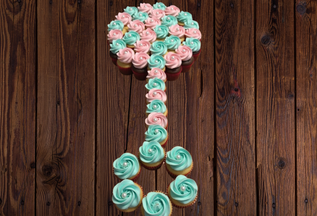 Rattle-shaped pull-apart cupcake cake with pink and blue rose swirl frosting for gender reveal baby shower