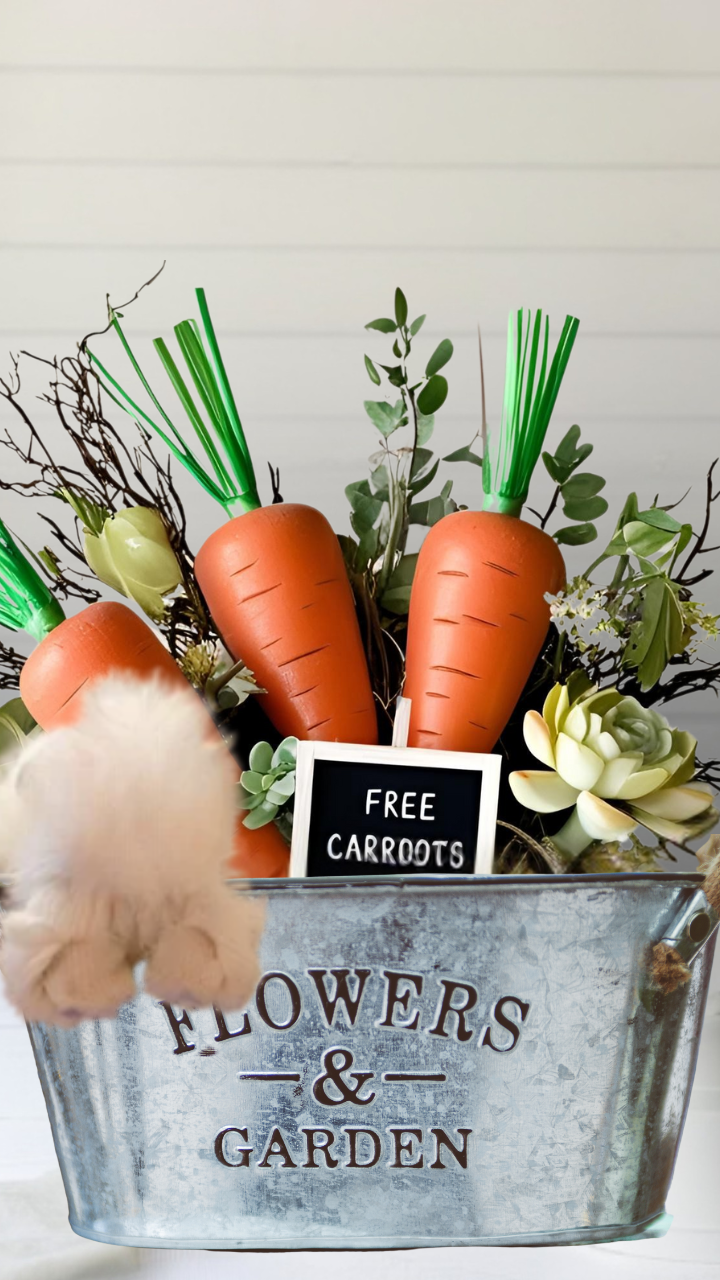 Easter bunny centerpiece with faux carrots, spring florals, and a 'Free Carrots' sign in a rustic garden bucket.