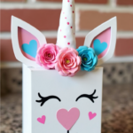 DIY Unicorn Valentine’s Box with a white base, pink and blue accents, a unicorn horn, and floral decorations, perfect for kids' Valentine’s Day card collection