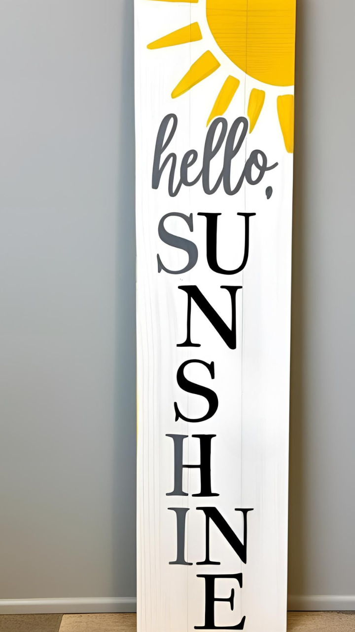 Tall wooden sign with 'hello, SUNSHINE' text and a yellow sun illustration on a white background.