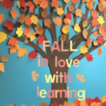 A colorful bulletin board display featuring a large tree with brown branches and a blue background. The tree is decorated with paper leaves in shades of red, orange, yellow, and brown. In the center, the phrase "FALL in love with learning" is written in multicolored letters, with small paper leaves accenting the text.